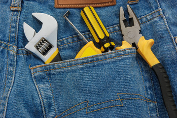 tools in a blue jean back pocket