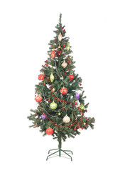 A beautiful green Christmas tree covered with toys and balls