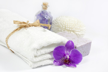 Obraz na płótnie Canvas Towel and orchid spa bath concept on white background