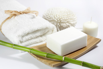 Fototapeta na wymiar Towel and spa soap on white background