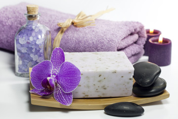 Obraz na płótnie Canvas Spa soap with towel and orchids on white background