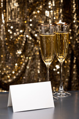 Champagne glasses with white card