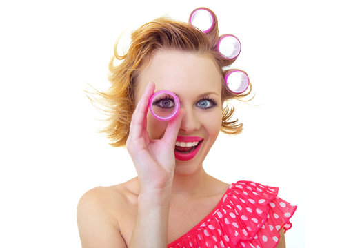 Funny woman with hair style looking thro curlers