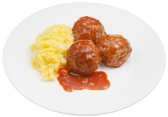 portion of roasted meatballs under meat sauce and mashed potato