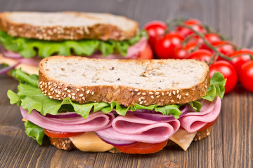 bun and sandwiches  on a wooden board