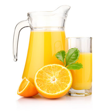 Jug, glass of orange juice and orange fruits with green leaves i
