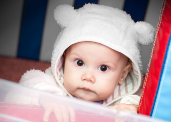 little baby in white bear costume on a playground