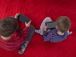 boys playing games on tablet computers