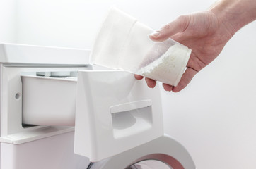 Pouring detergent into the washing machine