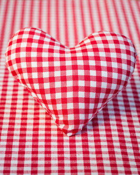 Red heart on gingham tablecloth
