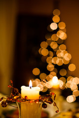 Christmas dinner table with candles with christmas tree