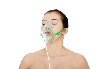 Diseased female patient wearing a oxygen mask