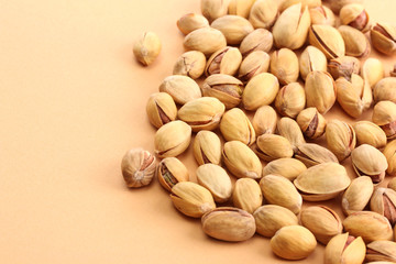 tasty pistachio nuts, on beige background