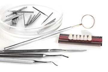denture with dental tools isolated on white