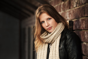 Teenage girl against a brick wall