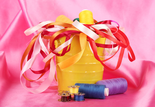 Color bucket with multicolor ribbons and thread