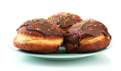 Tasty donuts on color plate isolated on white