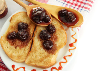 White bread toast with jam on plate, isolated on white