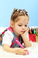 cute little girl playing with multicolor pencils,