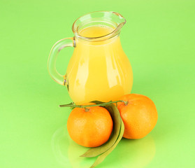 Full jug of orange juice, on wooden table on bright background