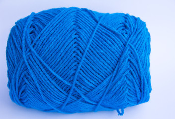 Blue ball of woollen thread isolated on white