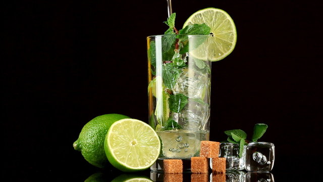Pouring soda in mojito