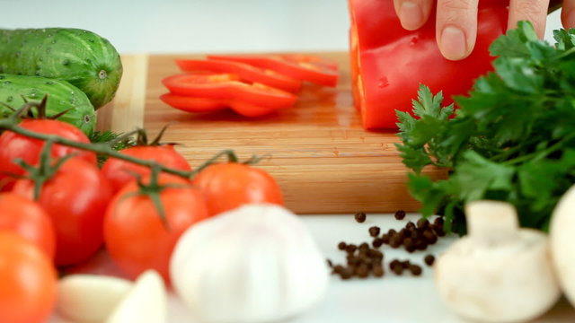 Female hands chopping red paprika(pepper)