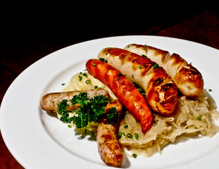 roasted sausages with sour cabbage and potato