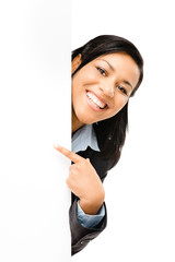 Happy mixed race business woman pointing at empty copy space iso