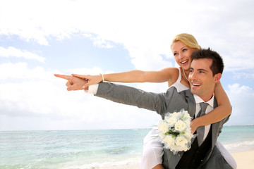 Honeymoon piggyback ride on the beach