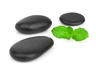 Fresh mint on the black stones with drops