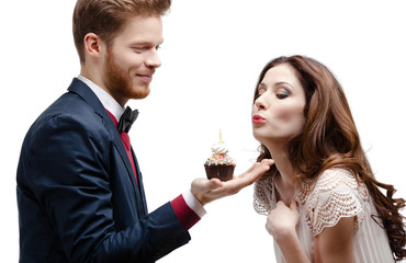 Man presents birthday sponge cake to his lovely girlfriend