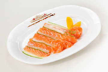 Fresh salmon with orange and cucumber on white background