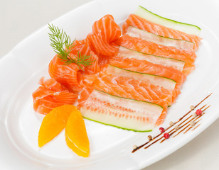 Fresh salmon with orange and cucumber on white background