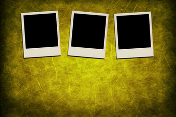 Blank instant photo frames on grunge yellow background