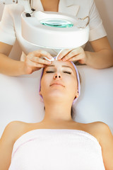 Young woman receiving beauty therapy