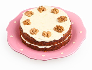 carrot cake with cream cheese frosting in a pink on white