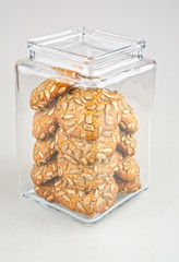 jar filled with cookie covered with seeds with clipping path