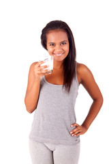 Fototapeta premium Happy african young female holding a glass of fresh milk