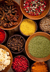 Various kind of spices in wooden bowls
