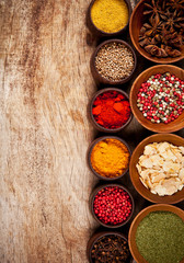 Various kind of spices in wooden bowls