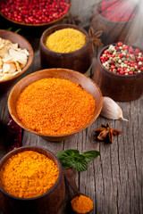 Various kind of spices in wooden bowls