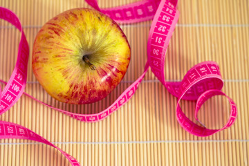 healthy diet: apple and measuring tape