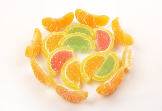 Pile tangerine and marmalade slices on a white background