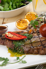 Piece of Medium Rare Steak with Spicy Herb Sauce