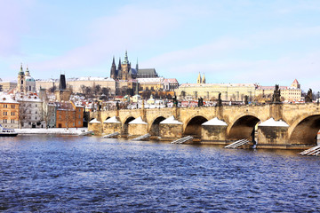 Snowy Prague gothic Castle with Charles Bridge in the sunny Day