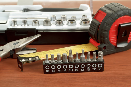 screwdriver toolbox with set of bits, pliers and measuring tape