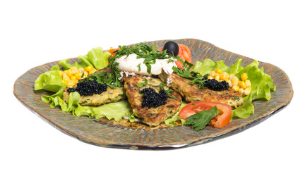 Roasted cutlets of potato with salmon on a plate