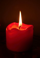 Red candles in front of a black background