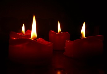Red candles in front of a black background